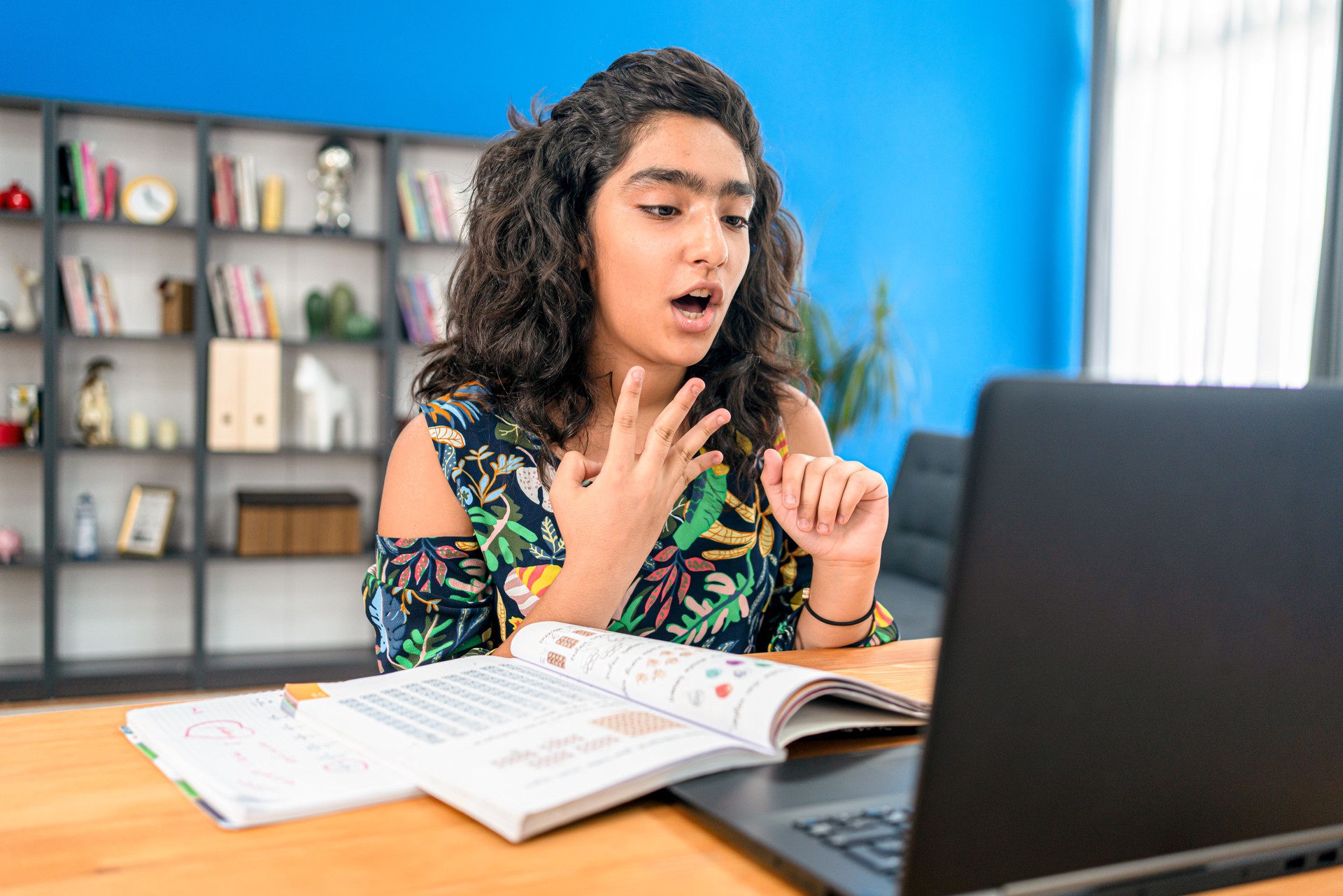 Teenage girl  having online school class at home